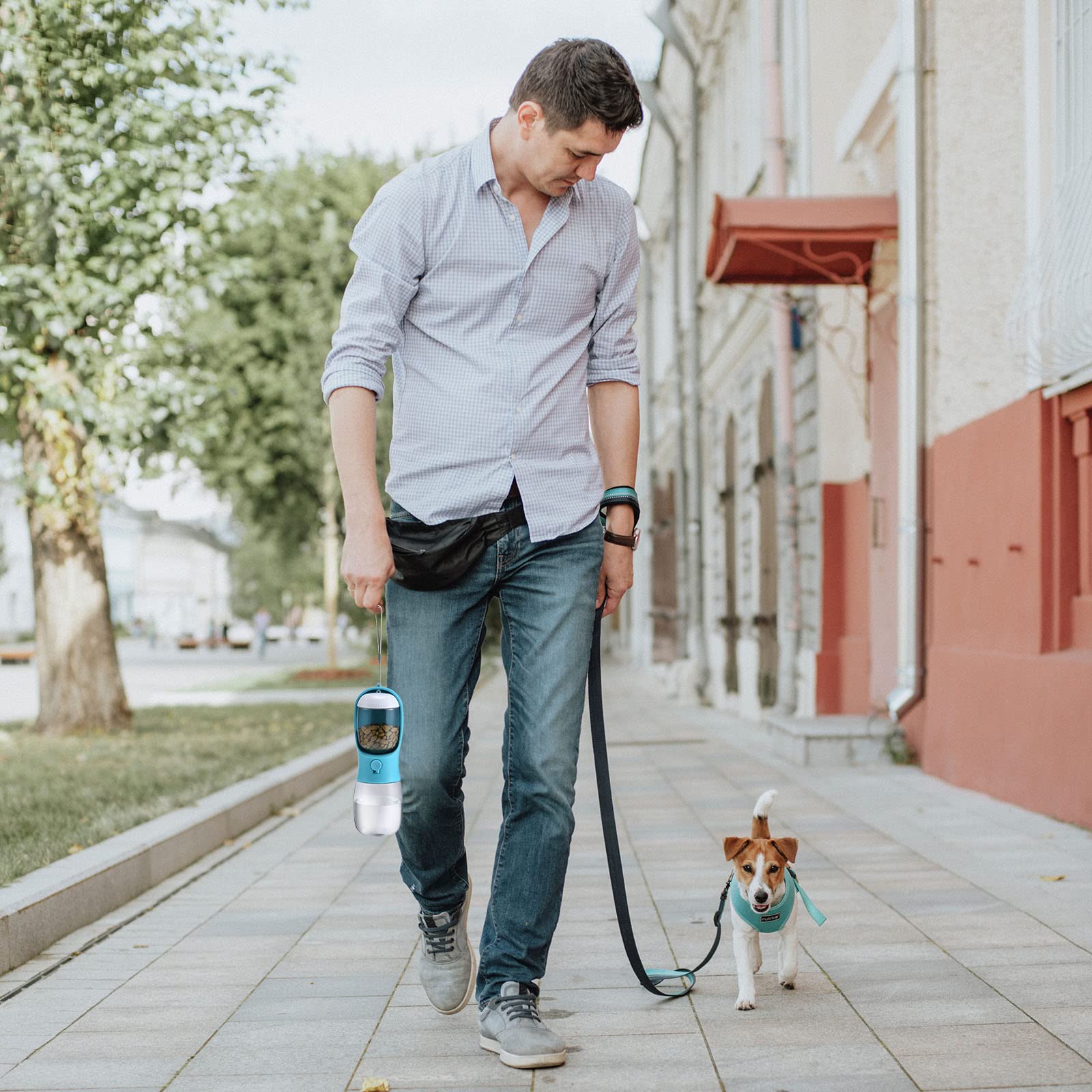 Man walking a dog on a leash in an urban setting